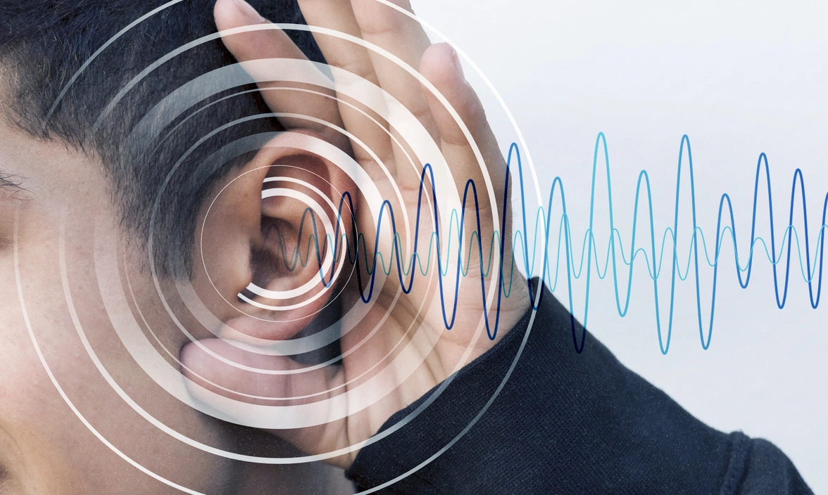 Side of a person’s head with their hand cupped around their ear and soundwaves surrounding the ear and going in or coming out