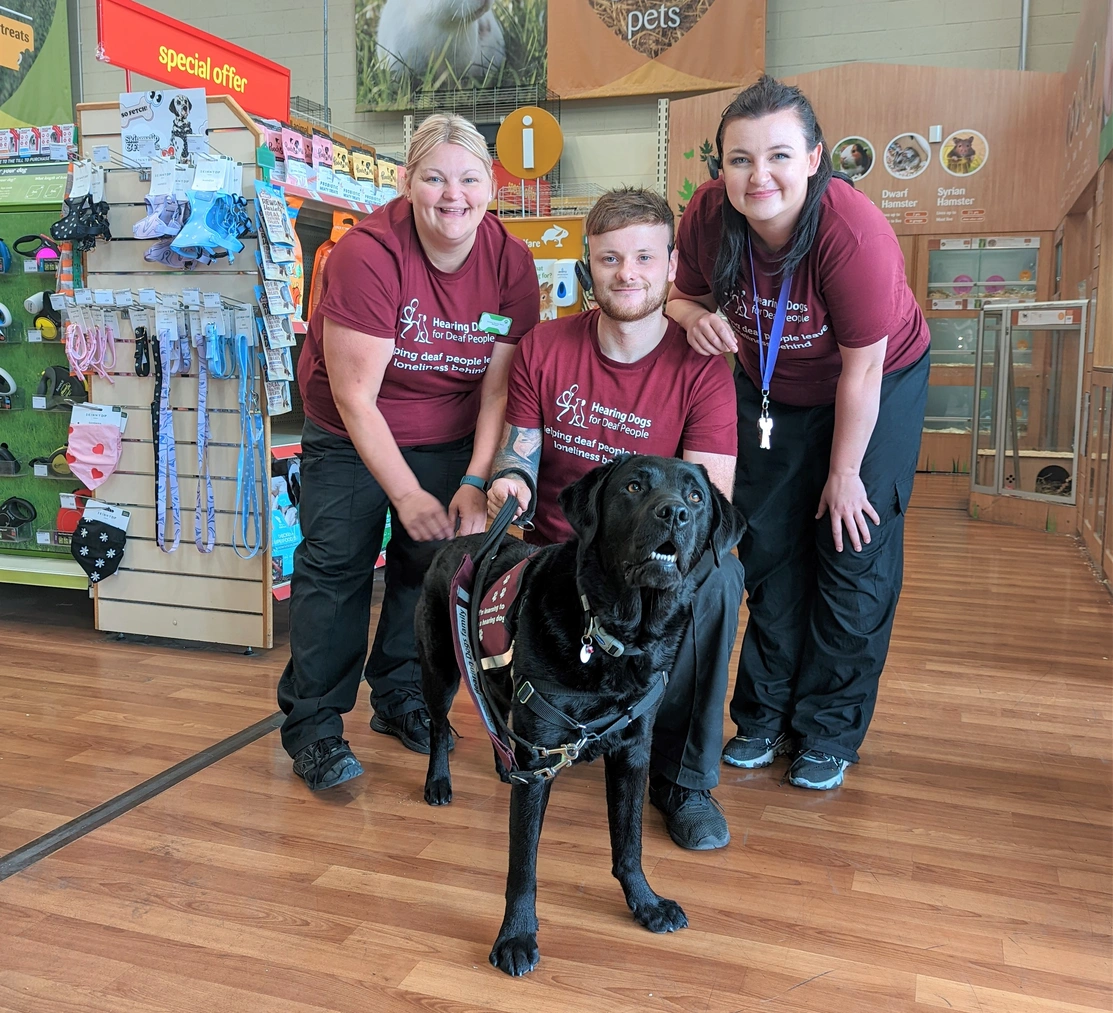 Colleagues at the Anlaby store with black labrador Dobby