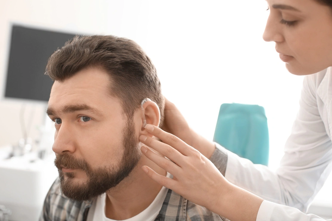 Close up of a man having a hearing aid fitted