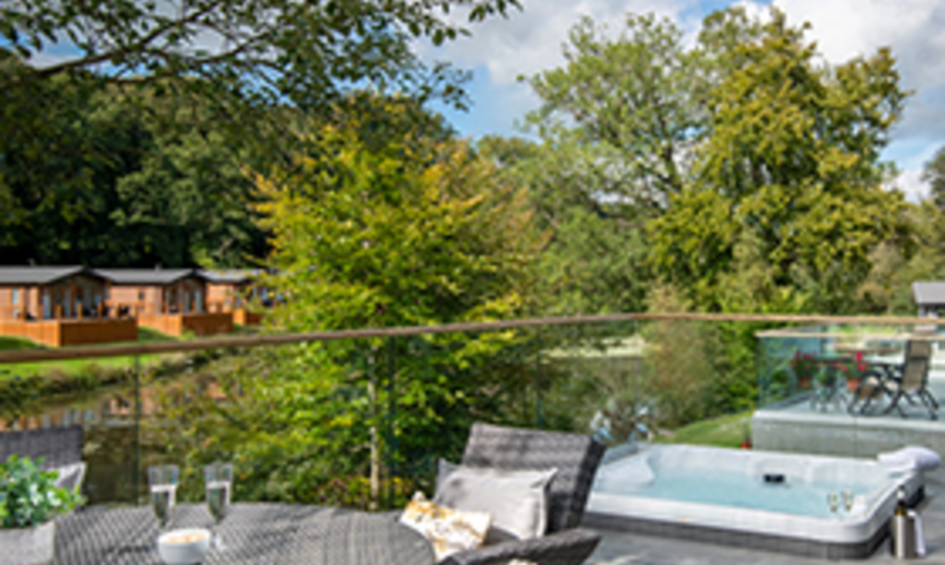 A balcony with table and chairs and a hotub