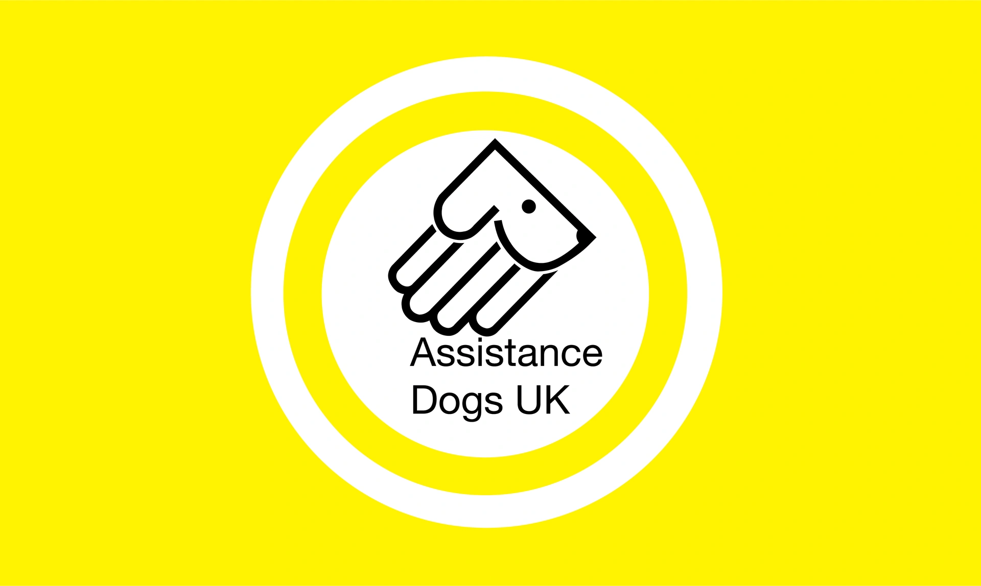 Assistance Dogs logo which is a handle and dog face combined on a yellow background