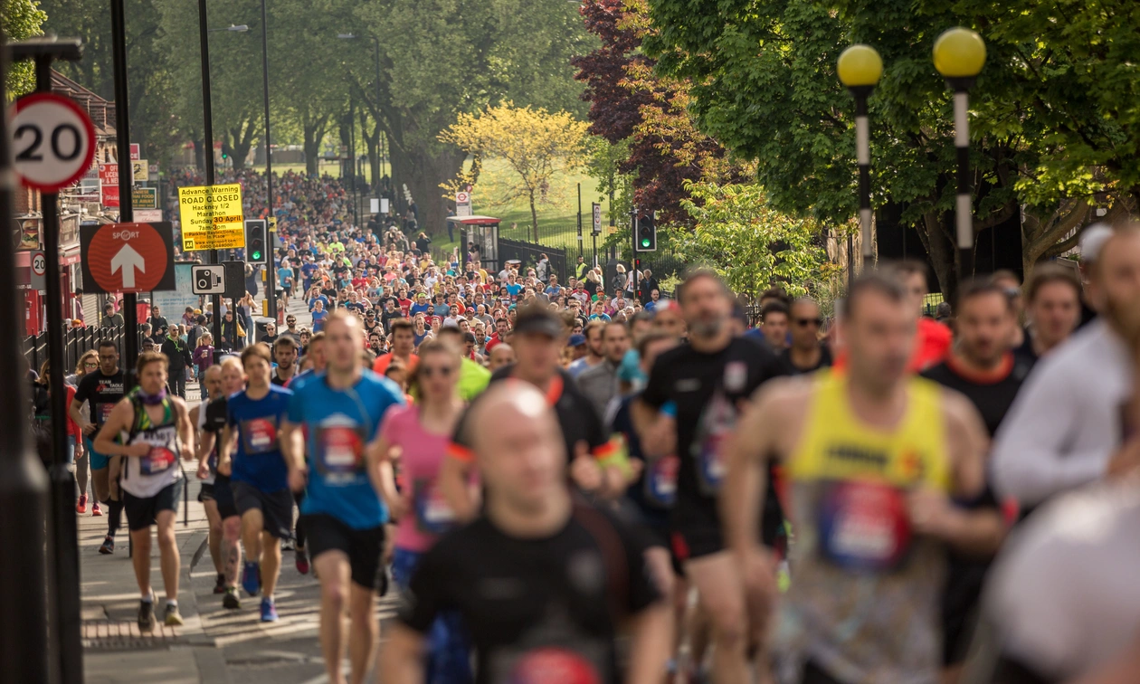 Thousands of runners take part in the Hackney Half Marathon, filling a tree-lined road as they run through east London.