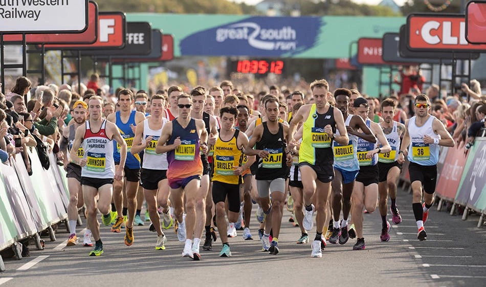 A photo taken from the head of a large group of marathon runners